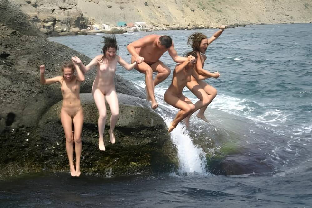 Mens and girls nudists on a beach - Naturism is about peace and tranquility