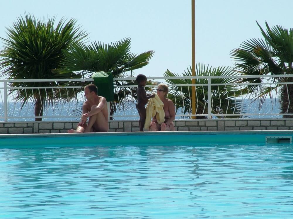 Photo of naturists in an outdoor pool - A space for those who seek bodily freedom